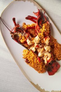 An exquisite plate of lobster risotto, perfectly arranged for a luxurious dining experience.